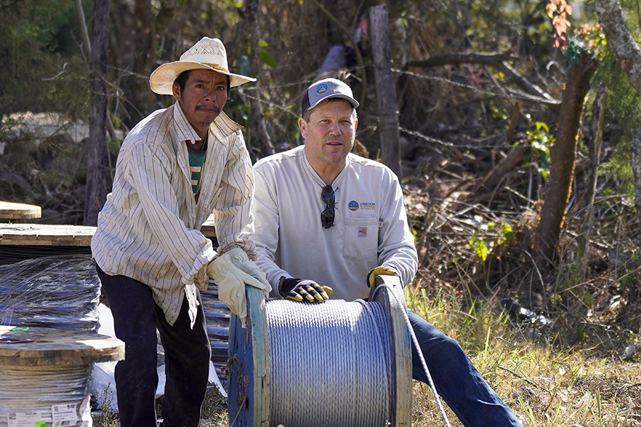 men with reel of wire